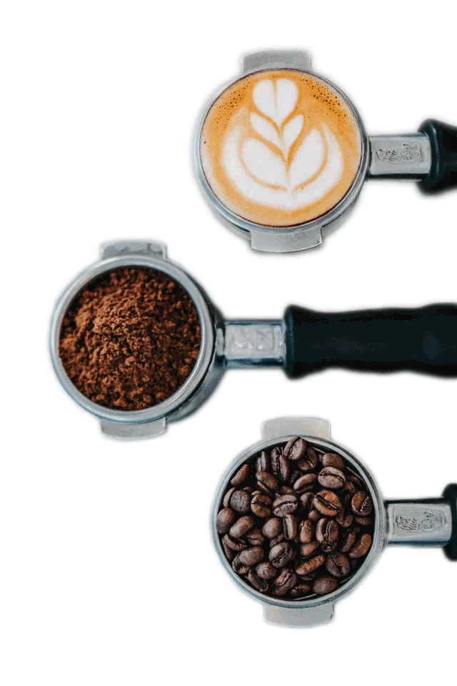Some coffee grounds, medium-dark roast coffee beans, and coffee latte