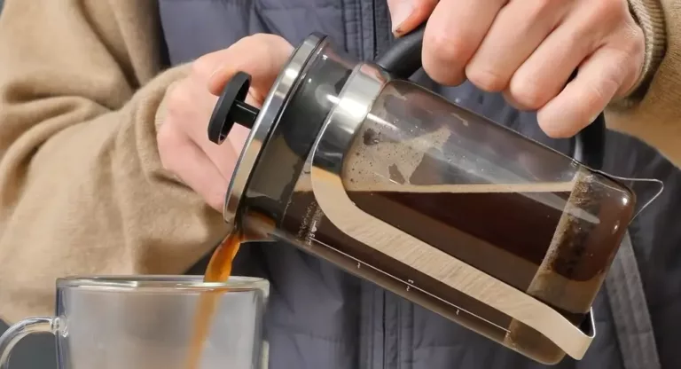 Pouring The French Press Coffee Into The Cup
